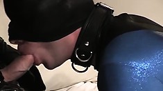 Gimp in a tight latex suit gives his daddy's big cock a suck