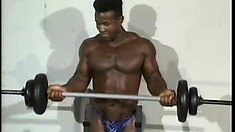 Horny black guy lifts some weights and then strokes his cock until he cums